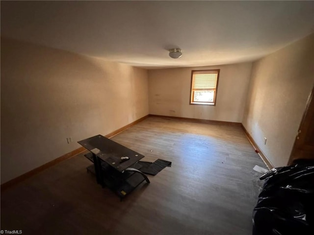 empty room with wood finished floors and baseboards