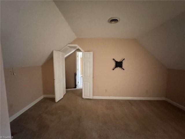 bonus room featuring visible vents, baseboards, and vaulted ceiling