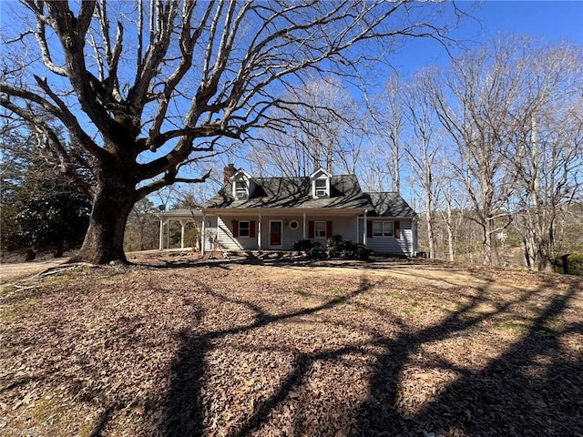 cape cod-style house featuring a porch