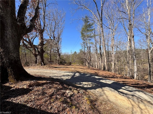 view of street featuring a forest view