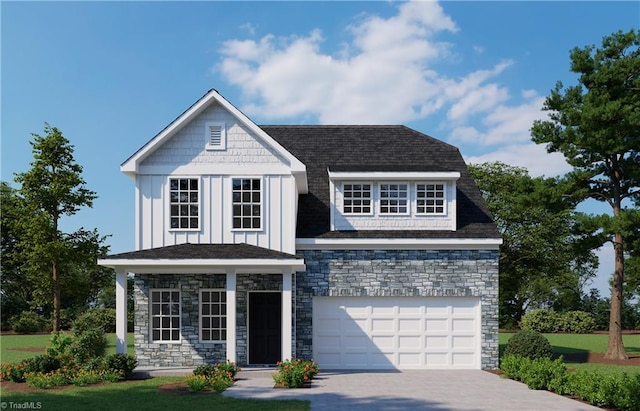 view of front of property with stone siding, a garage, board and batten siding, and driveway