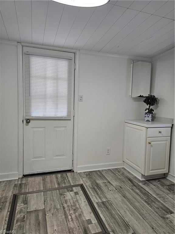 entryway with wood ceiling, baseboards, and wood finished floors