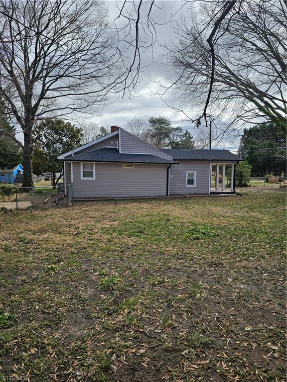 view of side of home featuring a lawn