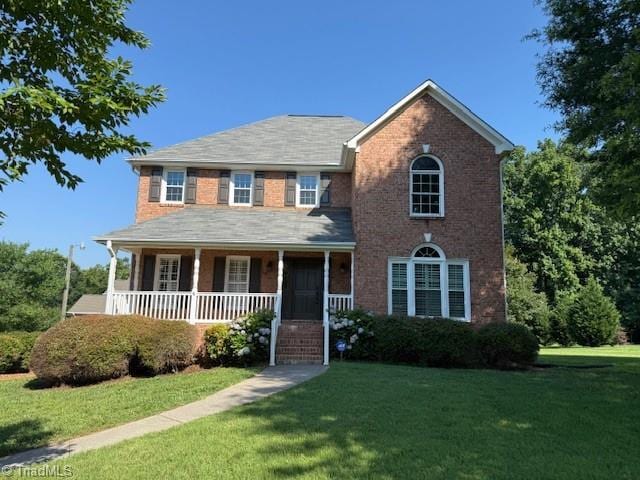121 Spring Lake Ct, Lexington, NC 27295 - colonial inspired home with a porch, a front yard, and brick siding