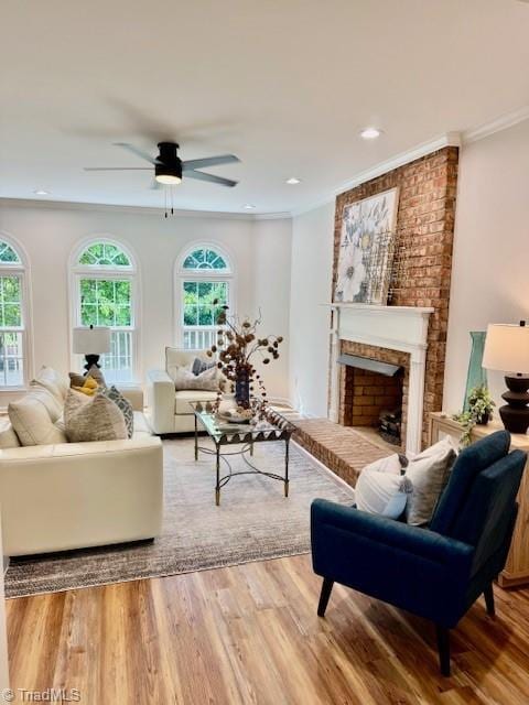 121 Spring Lake Ct, Lexington, NC 27295 - living area featuring wood finished floors, a ceiling fan, a brick fireplace, ornamental molding, and recessed lighting
