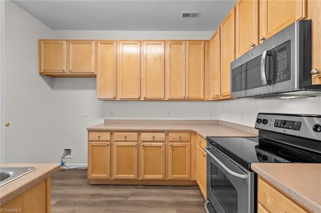 kitchen featuring light countertops, stainless steel appliances, visible vents, and light brown cabinets