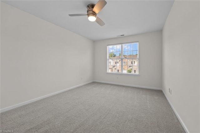 unfurnished room with baseboards, ceiling fan, visible vents, and light carpet