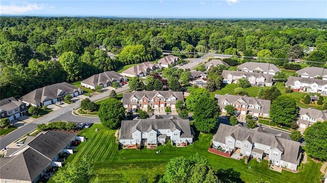 birds eye view of property with a forest view and a residential view