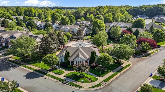 drone / aerial view featuring a residential view and a forest view