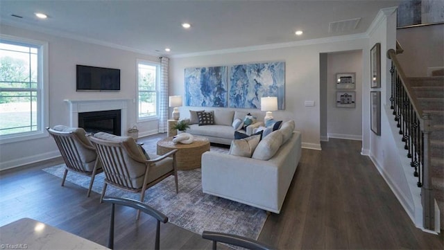 living room with dark hardwood / wood-style flooring and crown molding