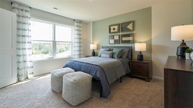 bedroom featuring light carpet