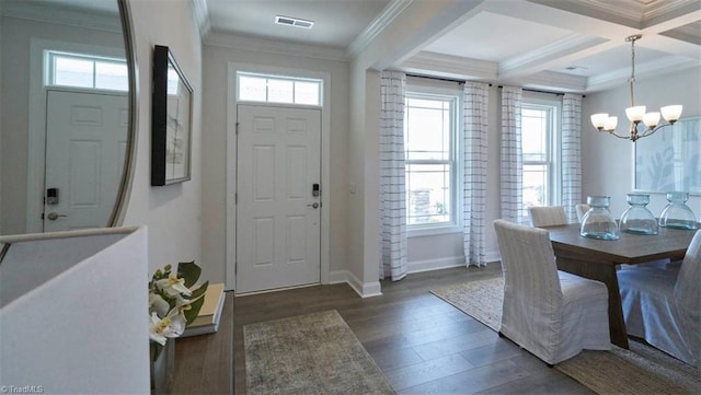 foyer with beam ceiling, coffered ceiling, an inviting chandelier, dark hardwood / wood-style flooring, and ornamental molding