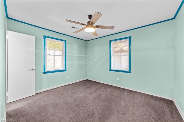 unfurnished room featuring ceiling fan, carpet floors, and ornamental molding