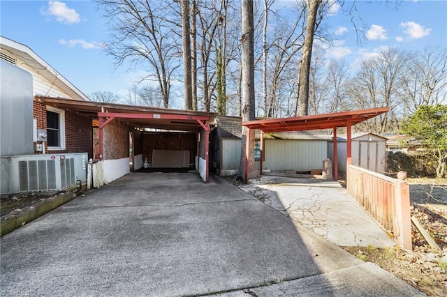 garage featuring a carport and central AC unit