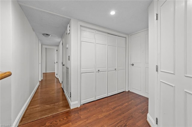 corridor featuring dark hardwood / wood-style floors