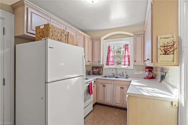 kitchen with decorative backsplash, sink, white appliances, and light brown cabinets