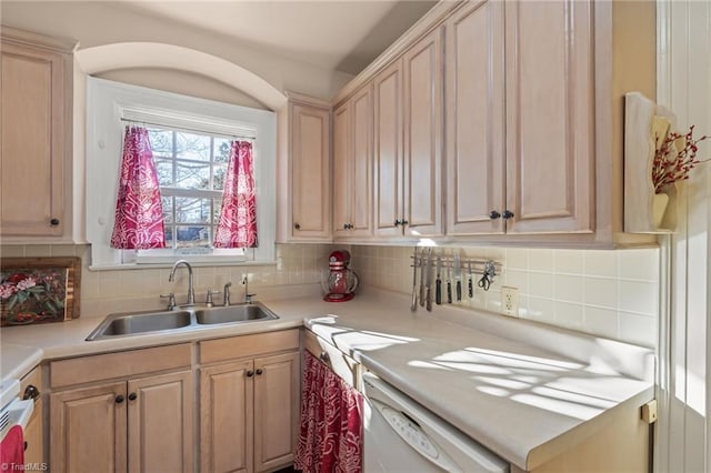 kitchen featuring dishwasher, light brown cabinets, decorative backsplash, and sink