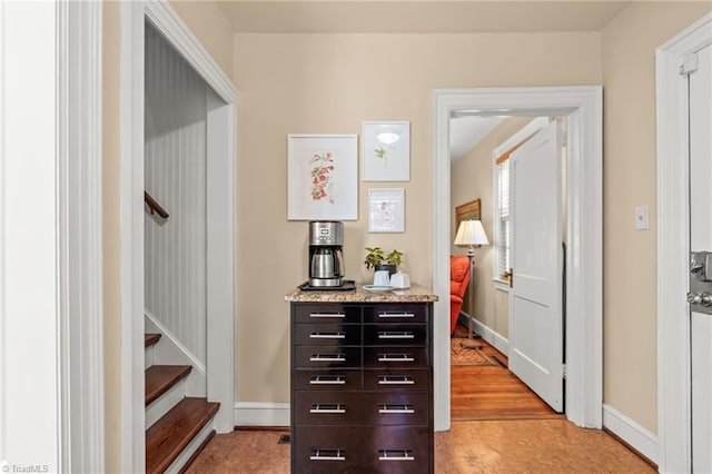 hallway with light hardwood / wood-style floors