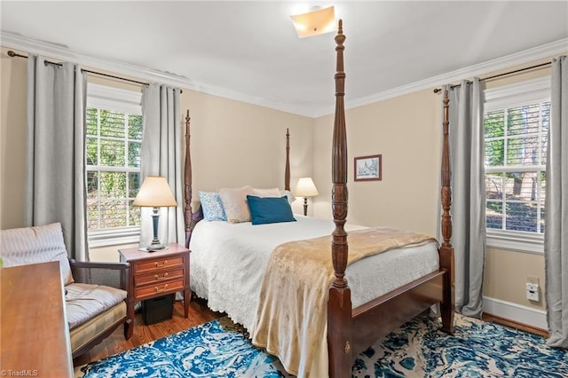 bedroom with crown molding and dark wood-type flooring