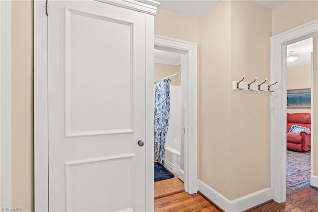 bathroom with hardwood / wood-style floors and shower / bath combo