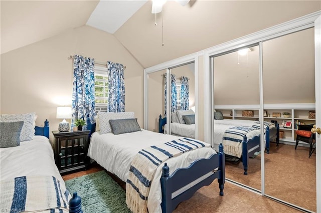 bedroom featuring ceiling fan, two closets, and vaulted ceiling