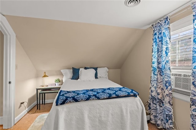 bedroom with vaulted ceiling and cooling unit