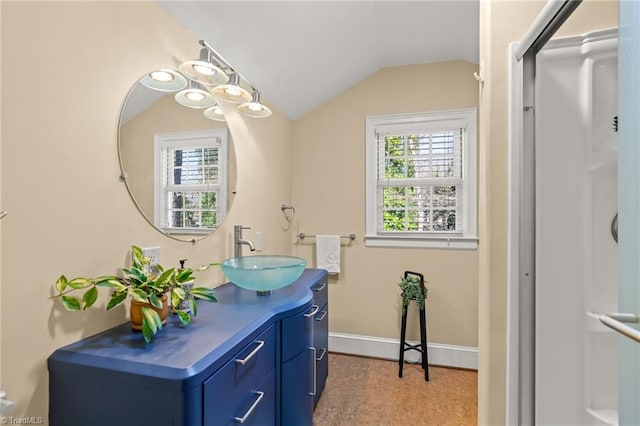 bathroom featuring vanity and lofted ceiling