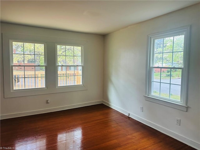 524 Ashburn St, High Point, NC 27260 - spare room featuring a healthy amount of sunlight, dark wood-style flooring, and baseboards