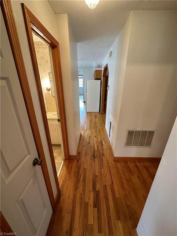 corridor featuring light hardwood / wood-style floors