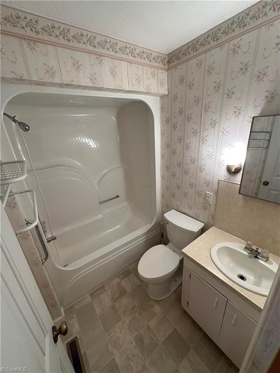 full bathroom featuring vanity, tile floors, toilet, and bathing tub / shower combination