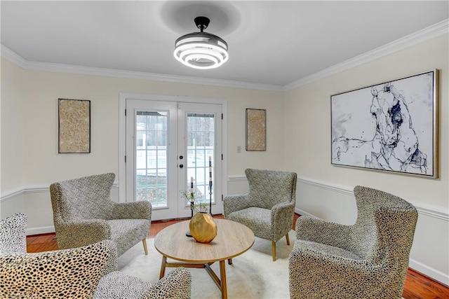 sitting room featuring french doors, hardwood / wood-style floors, and ornamental molding