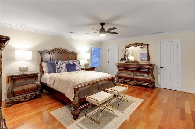 bedroom with hardwood / wood-style flooring, ceiling fan, and ornamental molding