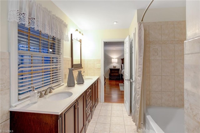 bathroom with tile patterned flooring, vanity, shower / bath combination with curtain, and tile walls