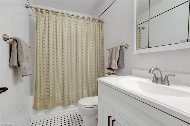 full bathroom with toilet, vanity, shower / tub combo with curtain, and tile walls