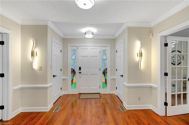 foyer entrance featuring light hardwood / wood-style flooring and ornamental molding