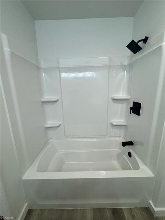 bathroom featuring shower / bathtub combination and wood finished floors