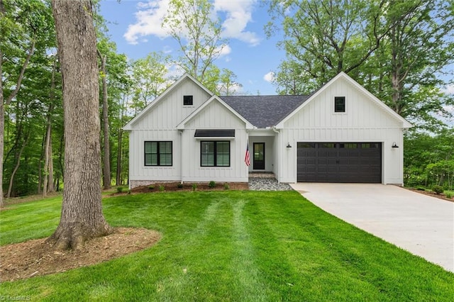 modern farmhouse featuring board and batten siding, driveway, a front yard, and a shingled roof