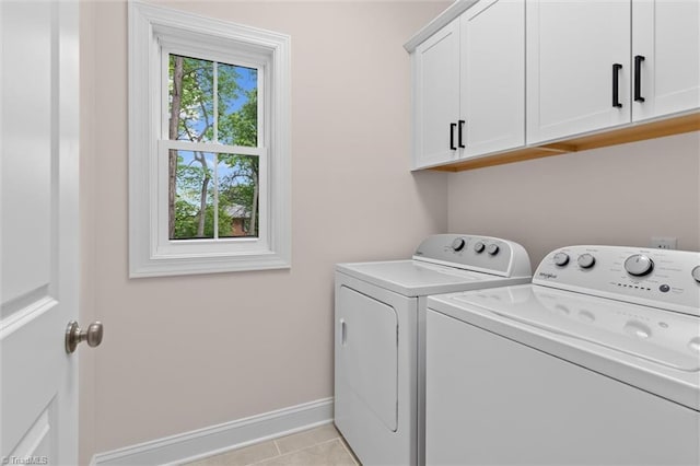 laundry room with cabinet space, washer and dryer, baseboards, and light tile patterned floors