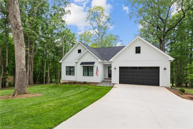 modern farmhouse style home with concrete driveway, a front yard, an attached garage, board and batten siding, and roof with shingles