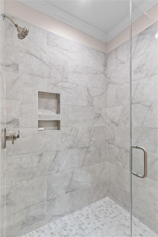 full bathroom with crown molding and a stall shower