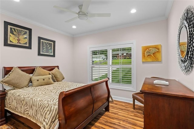 bedroom with wood finished floors, recessed lighting, crown molding, baseboards, and ceiling fan