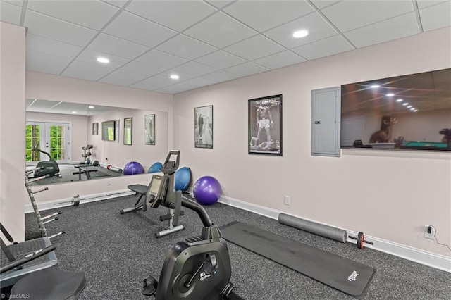 exercise area featuring electric panel, french doors, a paneled ceiling, baseboards, and recessed lighting