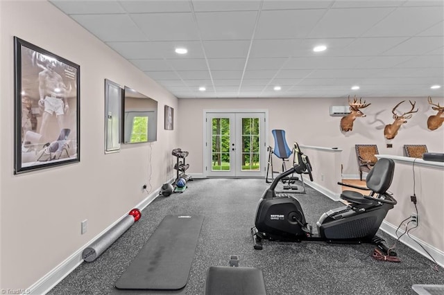 exercise area with a paneled ceiling, baseboards, recessed lighting, and a wall mounted AC