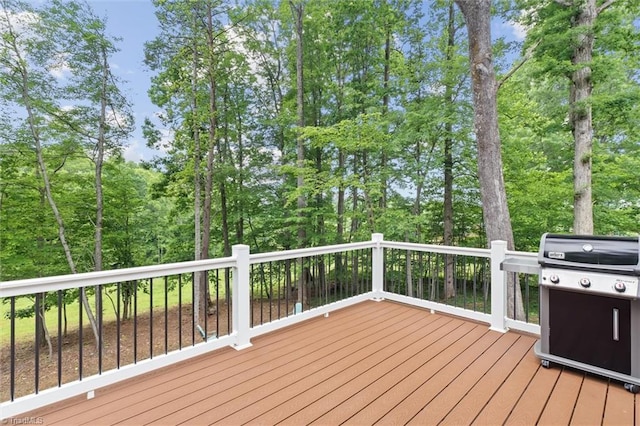 wooden deck featuring a grill