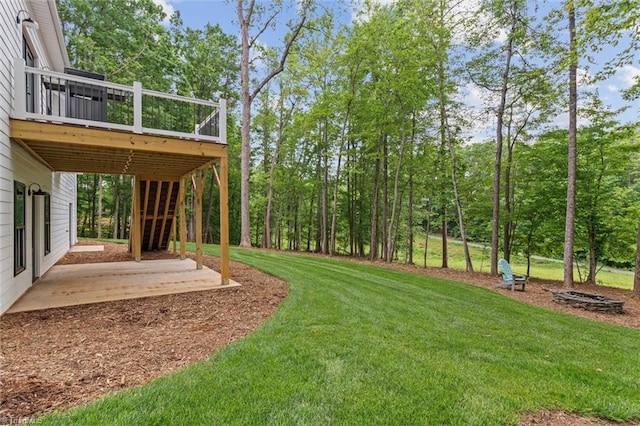 view of grassy yard featuring a deck, a patio area, and stairs