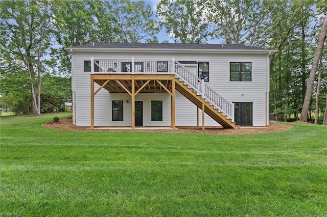back of property featuring stairs, a deck, and a lawn