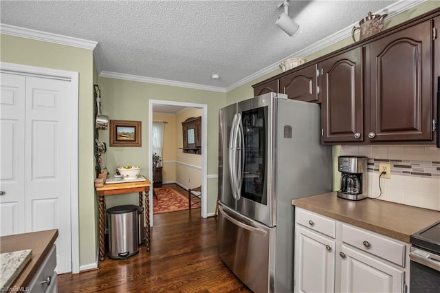 kitchen featuring crown molding, dark hardwood / wood-style flooring, dark brown cabinetry, and stainless steel appliances