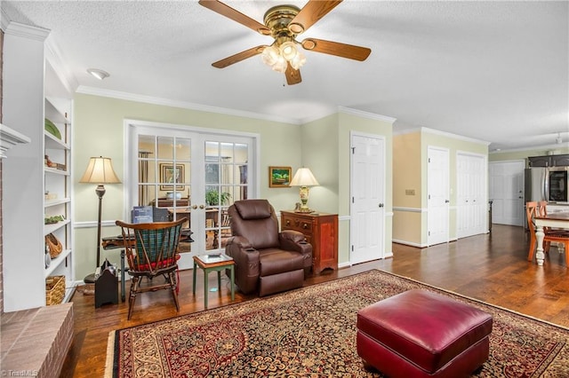 living room with ceiling fan, ornamental molding, dark wood-type flooring, and french doors