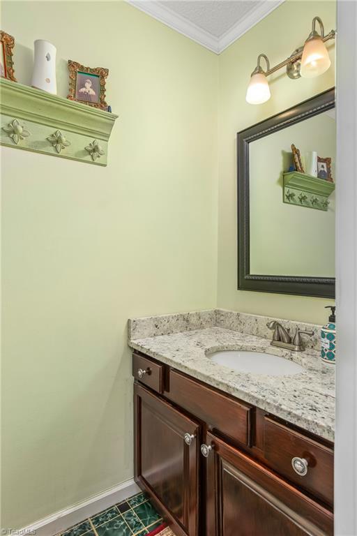 bathroom with vanity and crown molding