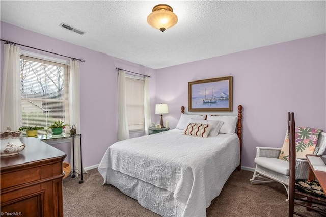 carpeted bedroom featuring a textured ceiling